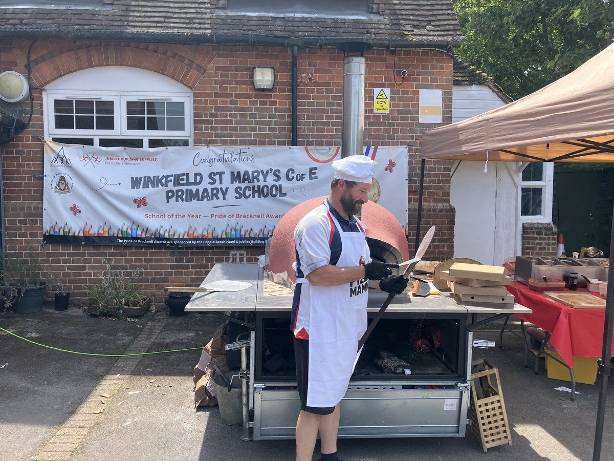 Pizza chef working the wood-fired oven at a school sports day