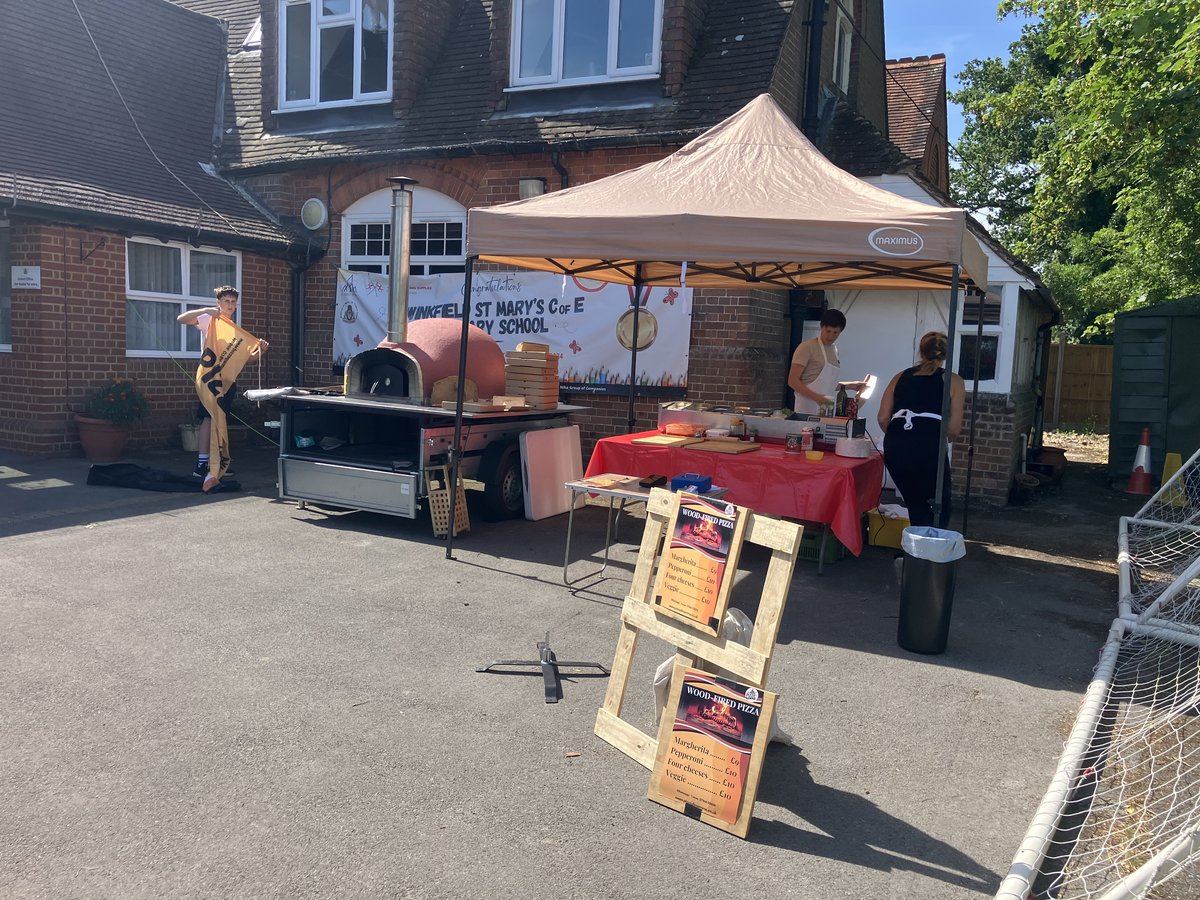 Wood-fired pizza oven and serving tables at a school fete event