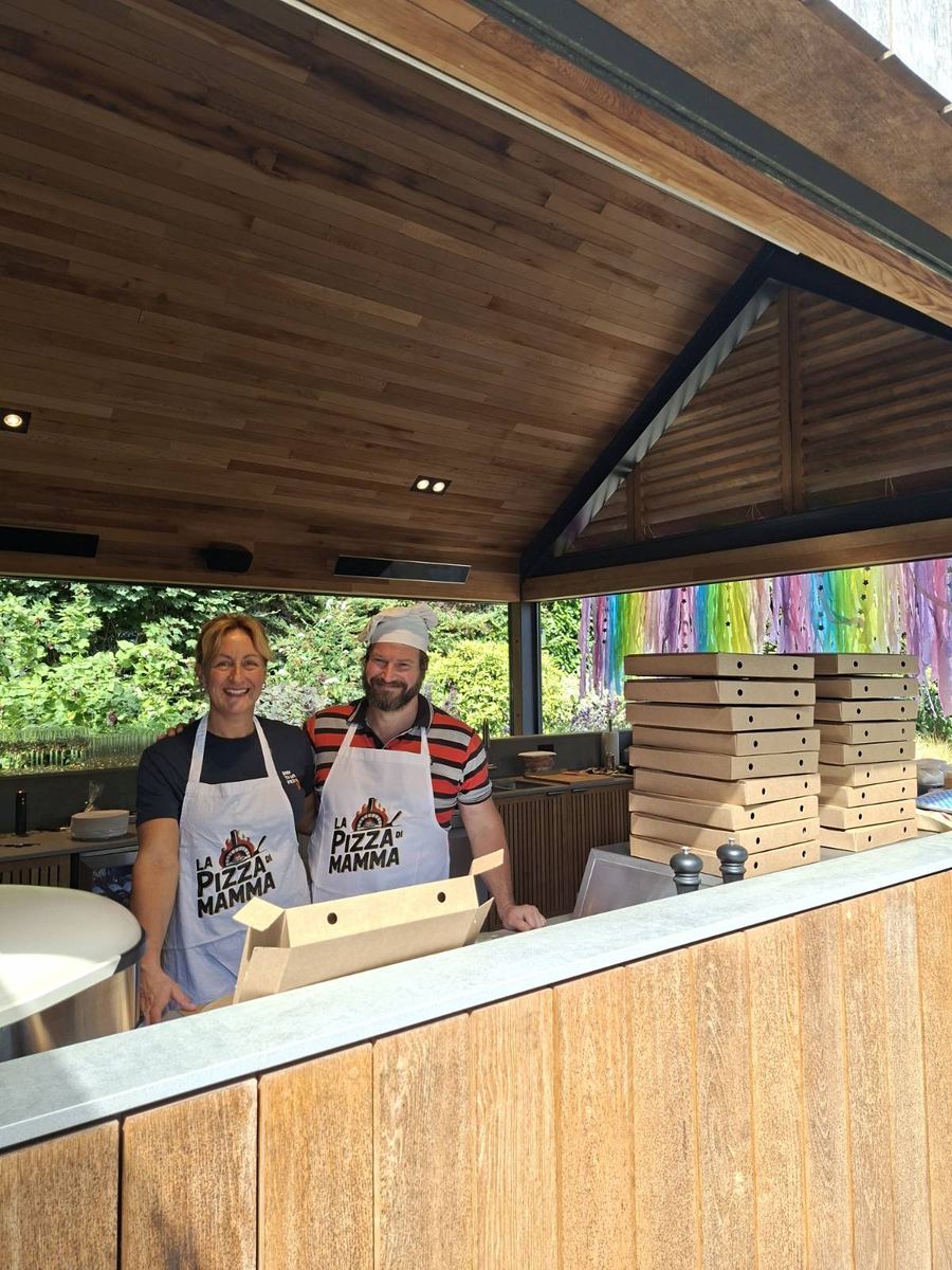 Pizza di Mamma team members behind their wooden event stall